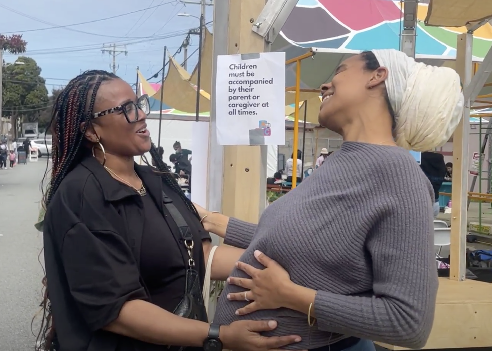 KaSelah Crockett (left) shares a tender moment with Chef Emaye, a vendor at the Pop-Up Village.
